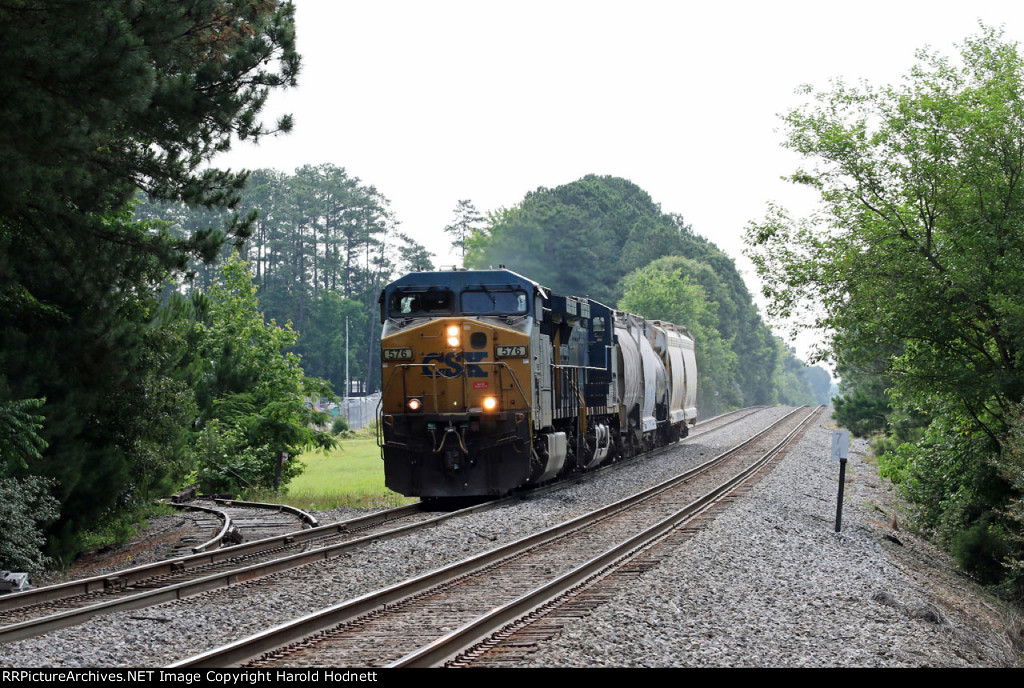 CSX 576 leads a short train L619-24 past the former Public Service gas plant (and siding)